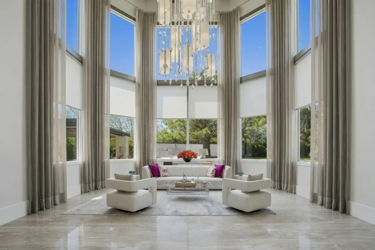 Henderson living room with Lutron motorized shades and full-height gray drapery