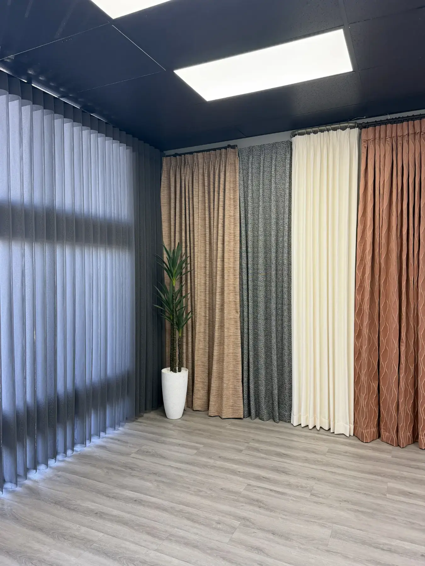 Full-size drapery and window covering displays inside the Southwest Blinds and Shutters Summerlin showroom